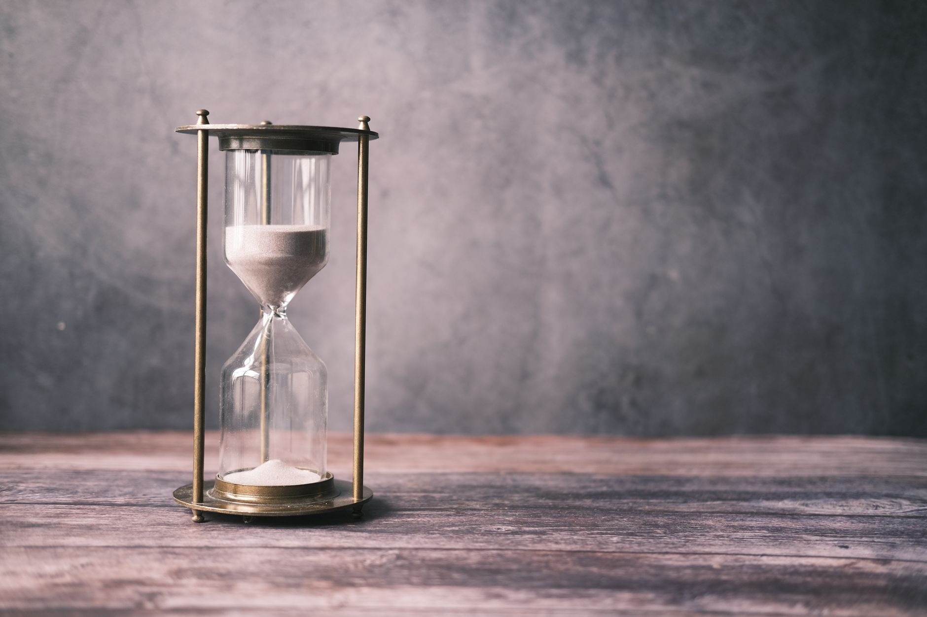 an hourglass on a wooden table